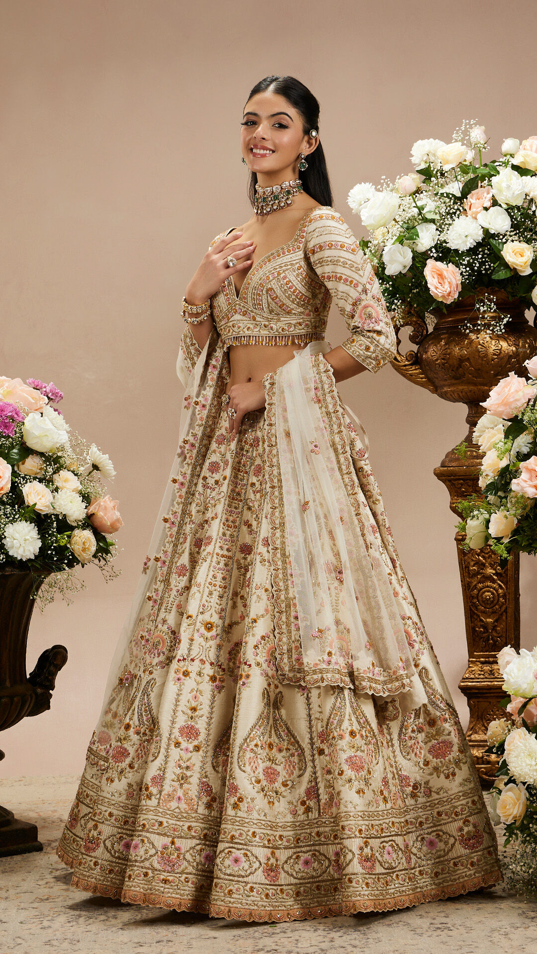 Bridal and occasion wear — exquisite white bridal gown with intricate embroidery on a soft neutral background