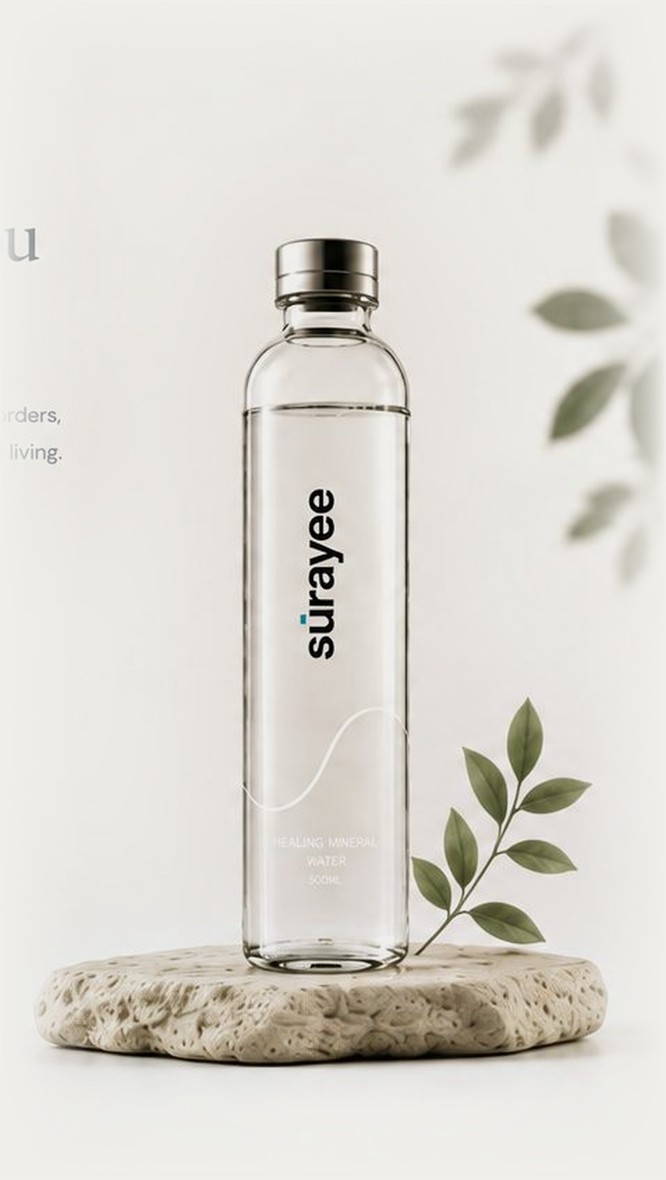 Surayee glass bottle resting on a stone beside eucalyptus leaves