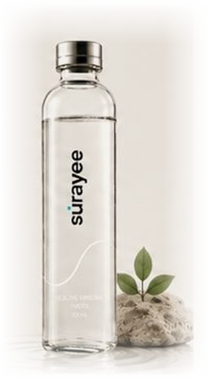 Surayee 500ml glass bottle beside a stone and leaf