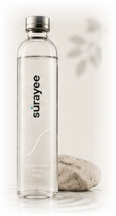 Surayee 750ml glass bottle beside a stone