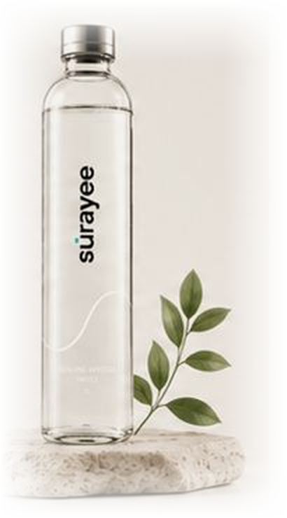 Surayee 1L glass bottle on a stone with leaves